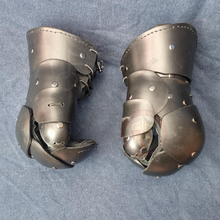 clamshell gauntlets on blue background